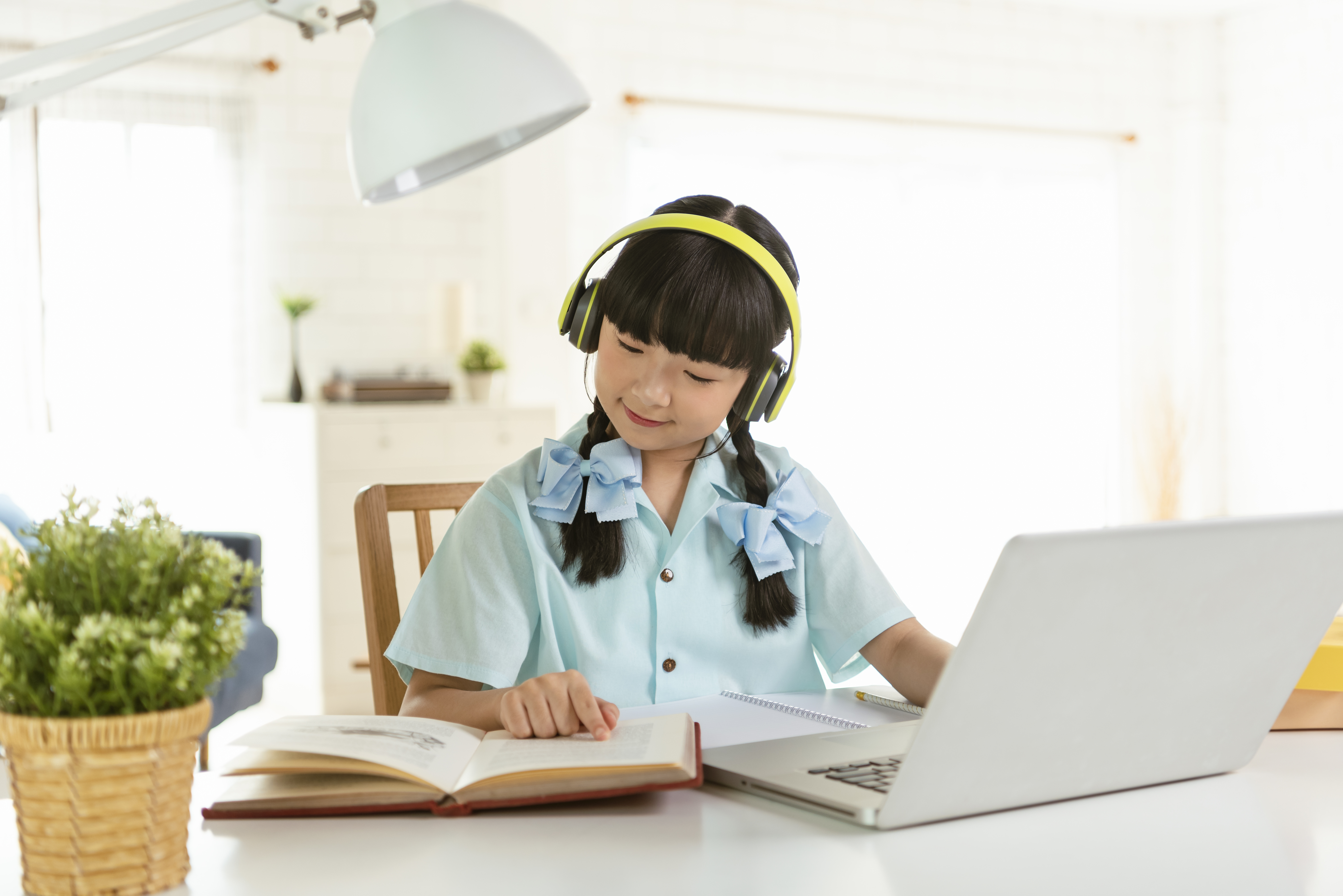 Homeschool Asian little young girl student learning virtual inte